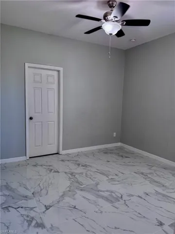 Empty room featuring ceiling fan