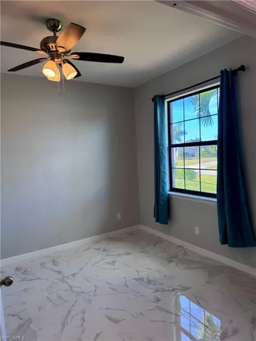 Unfurnished room featuring ceiling fan