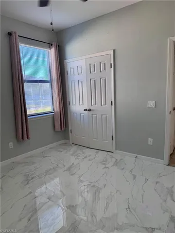 Unfurnished bedroom with a closet and ceiling fan