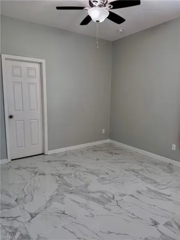 Spare room with ceiling fan