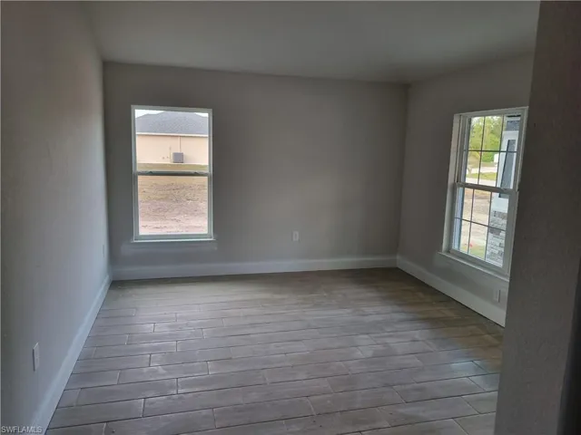 Empty room with light hardwood / wood-style floors