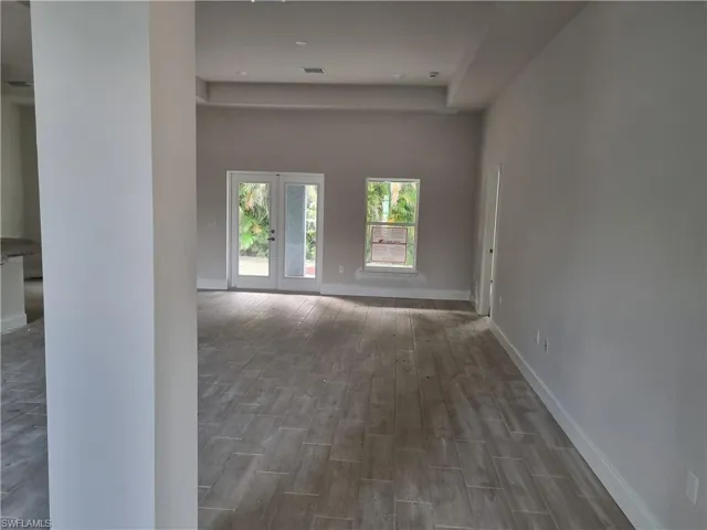 Spare room featuring french doors and wood-type flooring