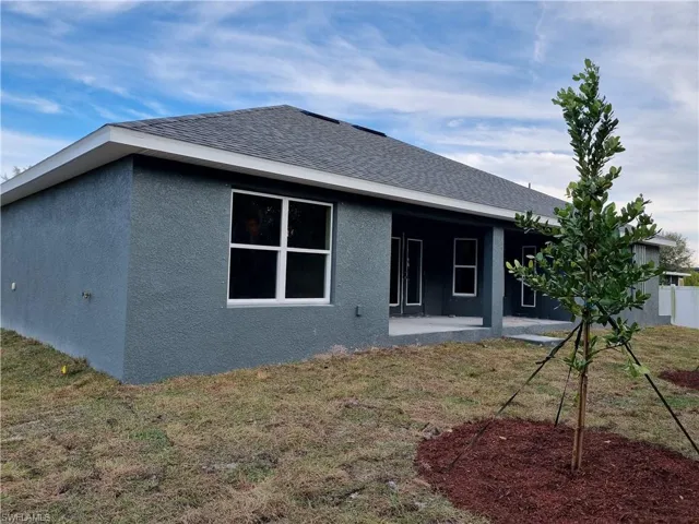 Back of property with a patio area and a yard