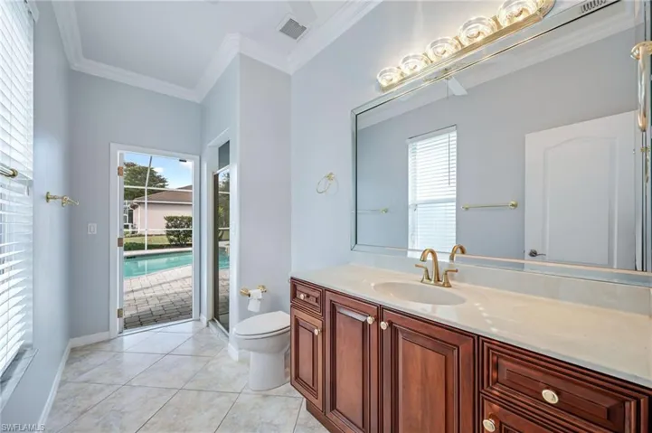 Bathroom with tile patterned floors, toilet, visible vents, and plenty of natural light