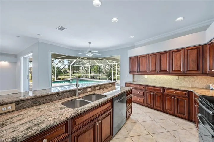Kitchen featuring visible vents, backsplash, crown molding, appliances with stainless steel finishes, and a sink