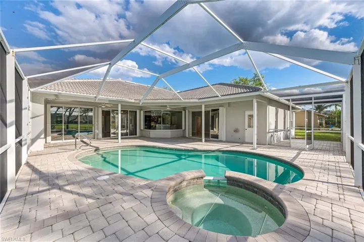 View of swimming pool with a lanai, a patio, ceiling fan, and a pool with connected hot tub