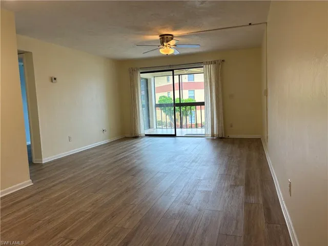 Large living room with sliders out to the screene lanai