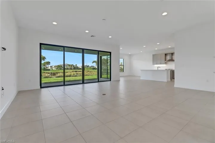 Unfurnished living room with baseboards, recessed lighting, and light tile patterned flooring