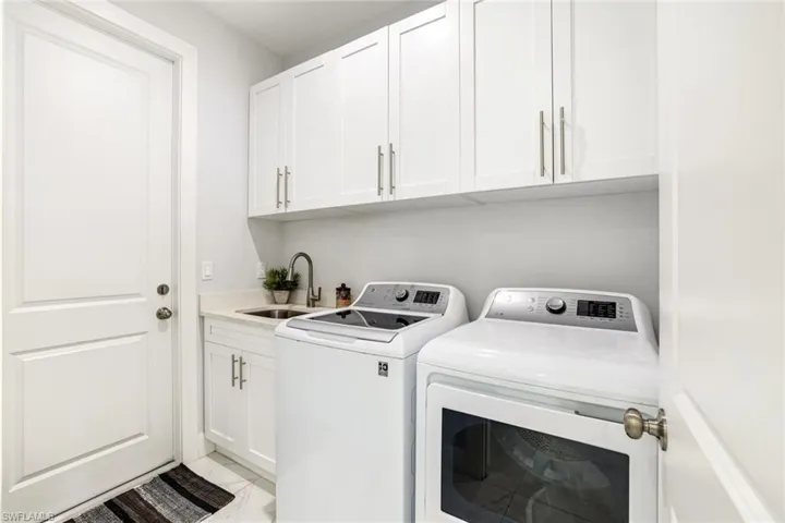 Laundry area featuring cabinet space and separate washer and dryer
