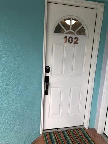 Property entrance featuring stucco siding
