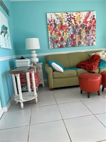 Living room featuring tile patterned floors and baseboards