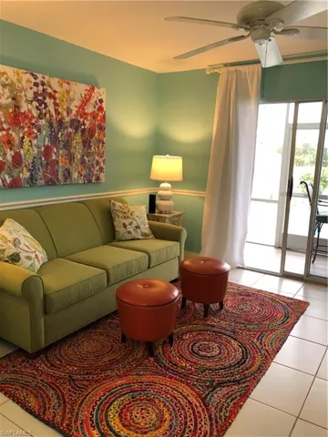 Tiled living room featuring ceiling fan