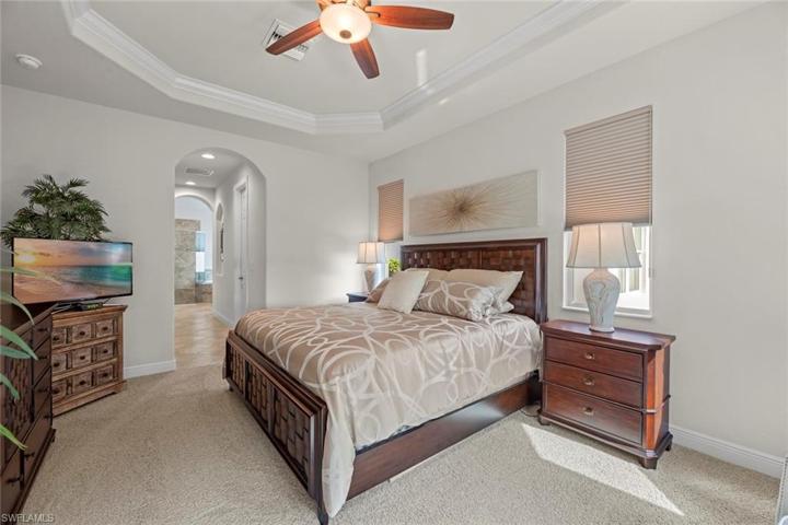 Arched h all leads to two walk-in closets and Master en-suite bath