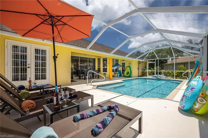 Outdoor pool with a patio, an outdoor living space, french doors, and glass enclosure