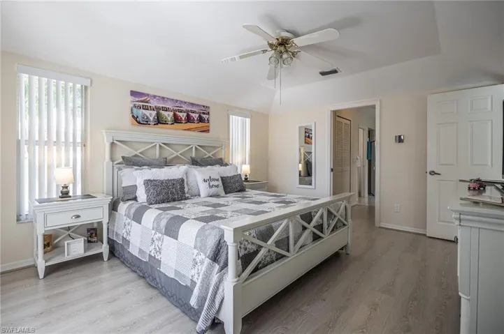 Bedroom featuring light wood-style flooring, baseboards, and ceiling fan