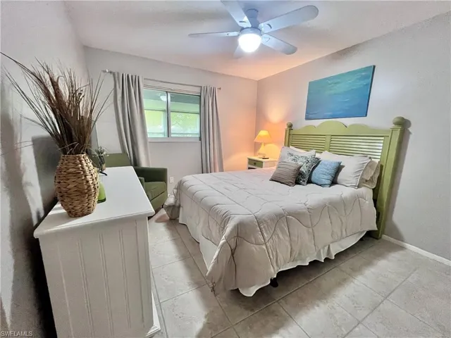Guest Bedroom featuring Queen Bed, ceiling fan and light tile floors