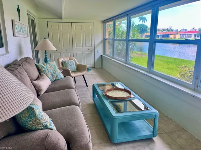 Sunroom featuring a water view