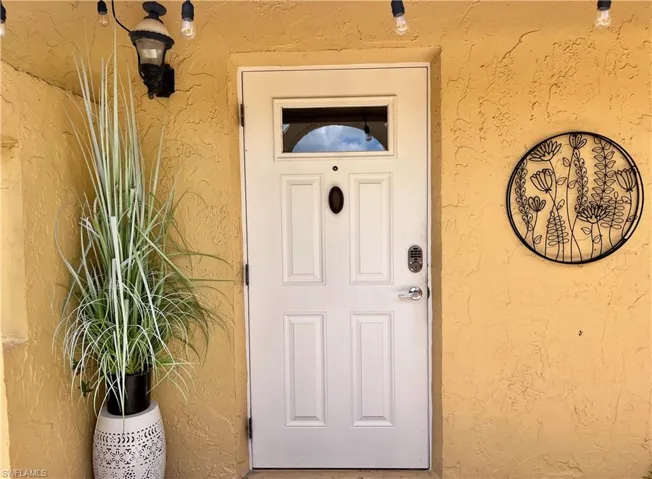 Doorway to property with stucco siding