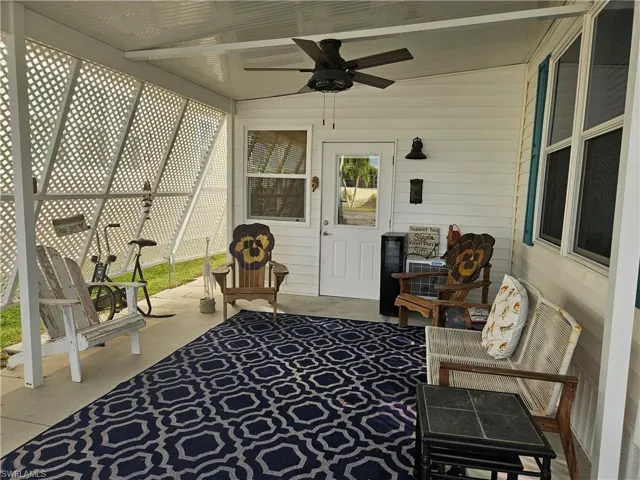 Sunroom / solarium featuring ceiling fan