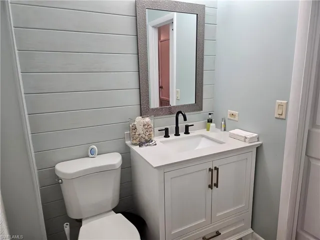 Half bath featuring toilet and vanity