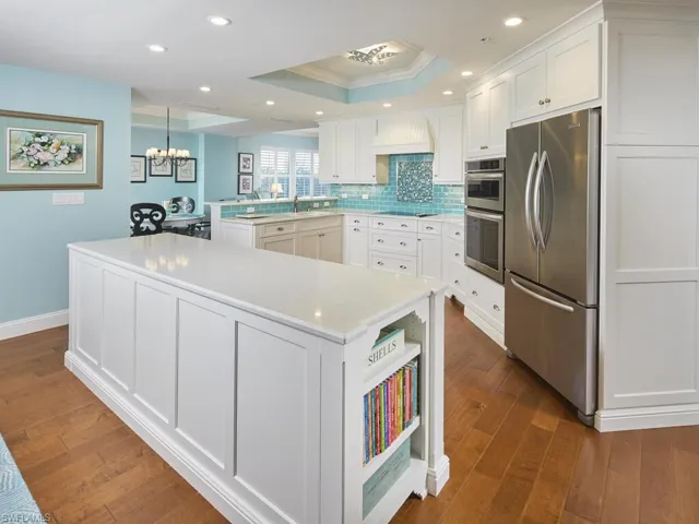 The kitchen provides ample storage space with shaker cabinets.