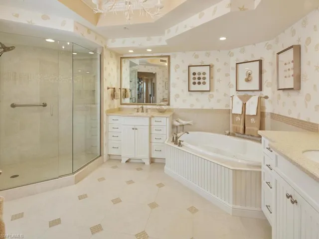 Dual sinks, spacious shower and a large detailed soaking tub.  Bathroom also boasts custom lighting and mirrors.