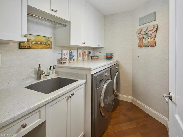 Laundry room offers a laundry tub and PLENTLY of additional storage space.