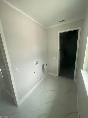 Laundry area with tile flooring, washer hookup, and hookup for an electric dryer
