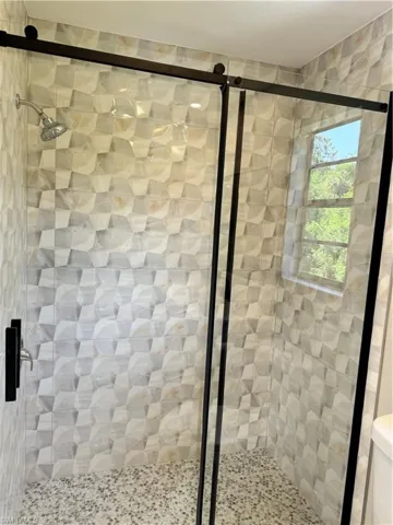 Bathroom featuring walk in shower and toilet