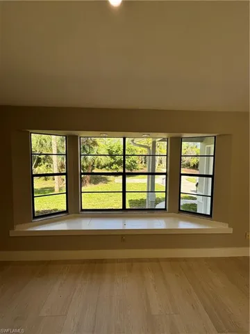 Spare room featuring a wealth of natural light and hardwood / wood-style flooring