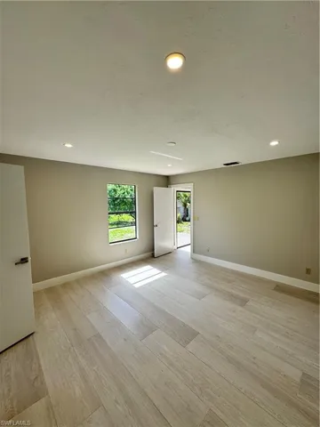 Unfurnished room with light hardwood / wood-style floors