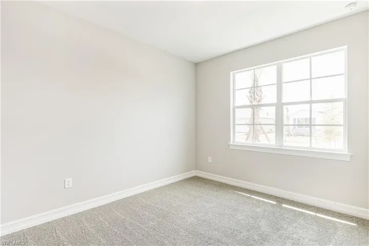 Empty room featuring baseboards and carpet floors