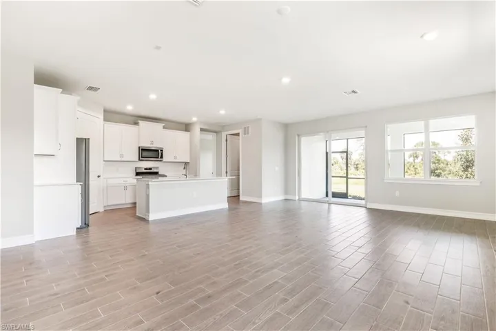 Unfurnished living room featuring recessed lighting and wood finish floors