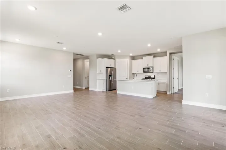 Unfurnished living room with recessed lighting and light wood-style flooring