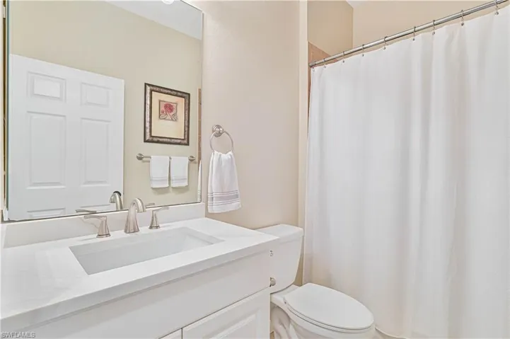 Full bathroom with a shower with shower curtain and vanity