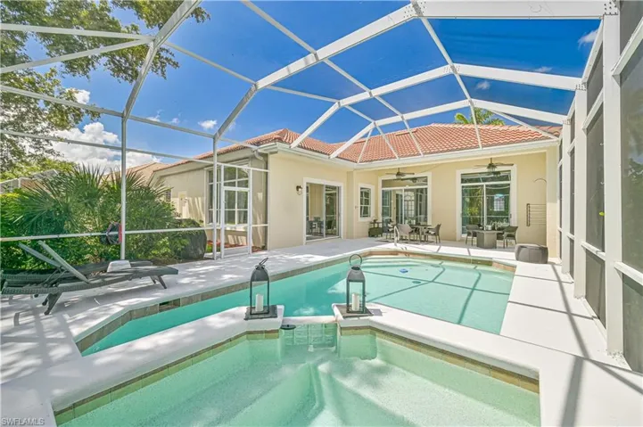 Integrated pool / spa featuring a sunroom, a patio, a lanai, and outdoor dining area