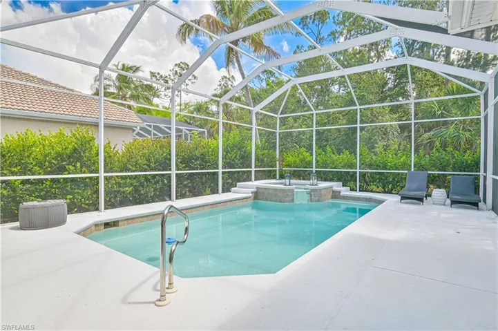 Integrated pool / spa featuring a patio area, glass enclosure, and a sunroom