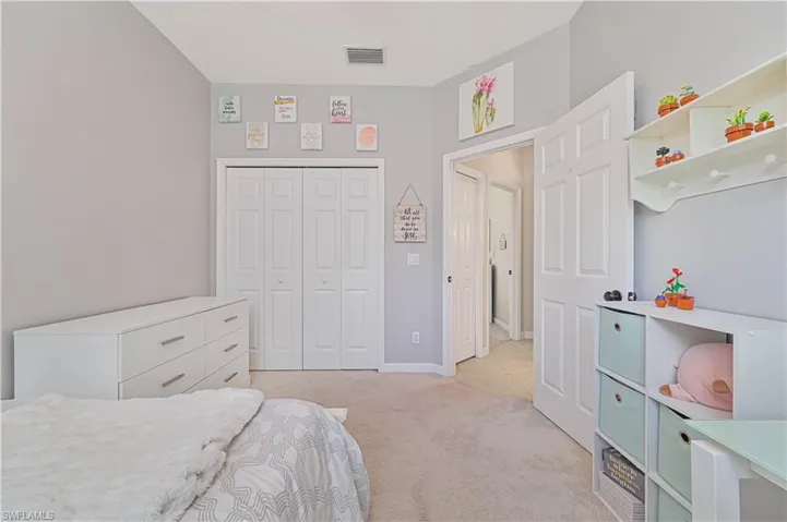 Bedroom featuring a closet and light carpet