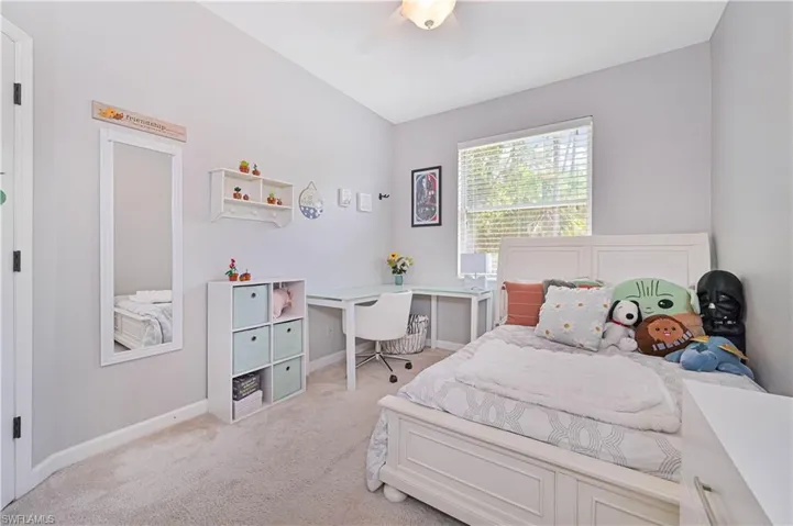 Bedroom featuring carpet floors, ceiling fan, and an office area