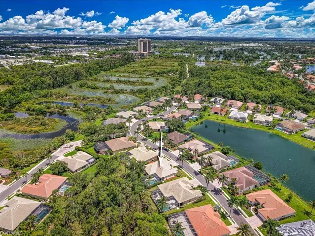 Aerial perspective of suburban area featuring a nearby body of water