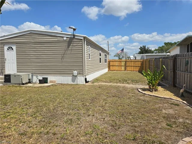 View of home's exterior with a fenced backyard and a central AC unit