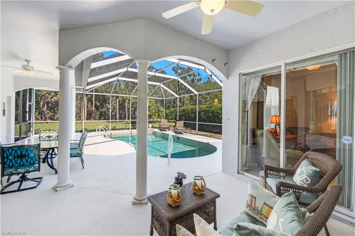 Outdoor pool with a patio area, a sunroom, and a lanai