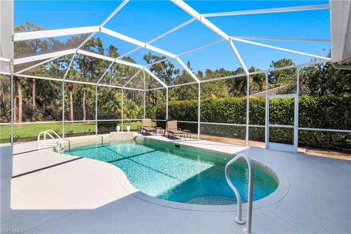 Swimming pool with a lanai, a sunroom, and a patio area