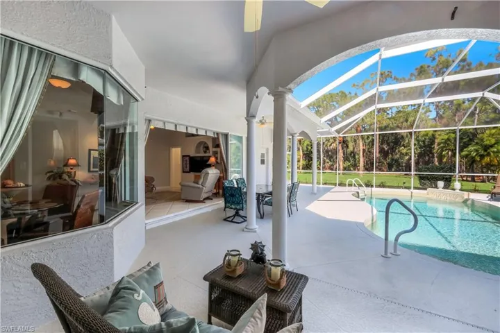 Swimming pool featuring a patio area, a sunroom, a lanai, and outdoor dining area