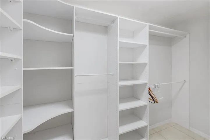 Walk in closet featuring light tile patterned flooring