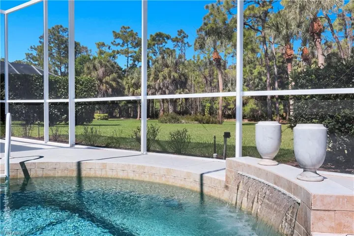 Outdoor pool featuring a lawn