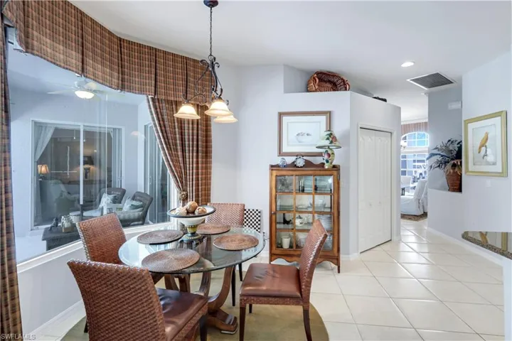 Dining room featuring light tile patterned flooring and recessed lighting