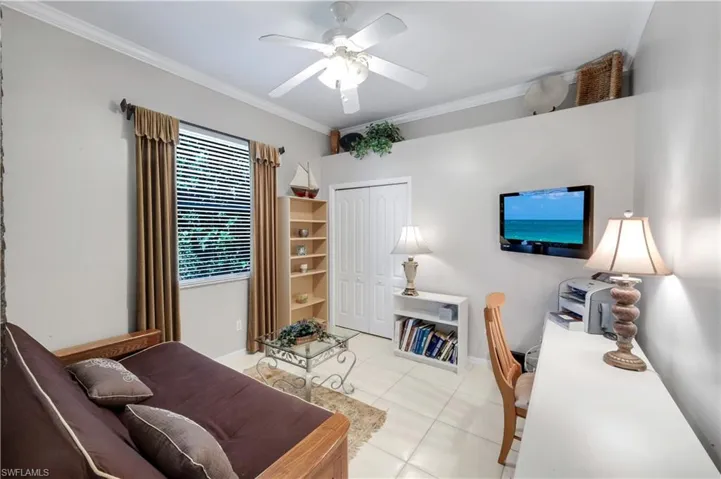 Home office with ornamental molding, a ceiling fan, and light tile patterned floors