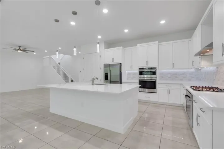 Spacious kitchen features ample pantry, large island, double ovens, gas cooktop and plenty cabinets for storage.