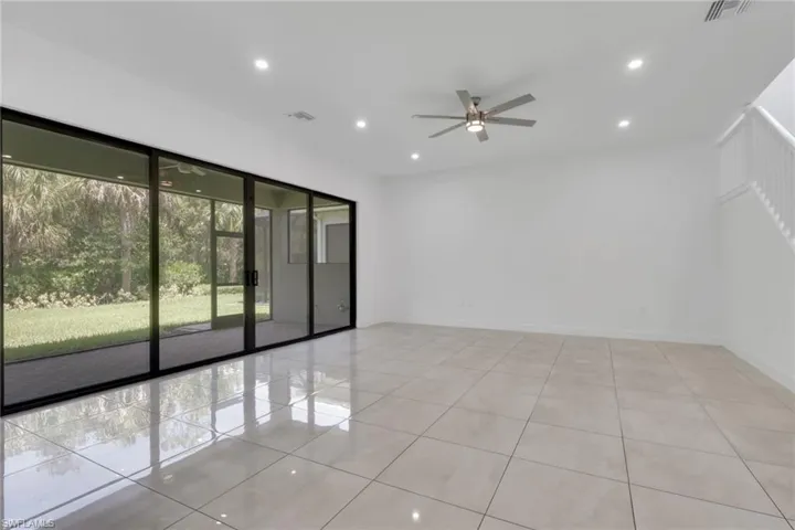 Living room has large sliding doors for ample natural daylight.